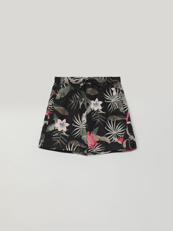 Tropical print swimming trunks