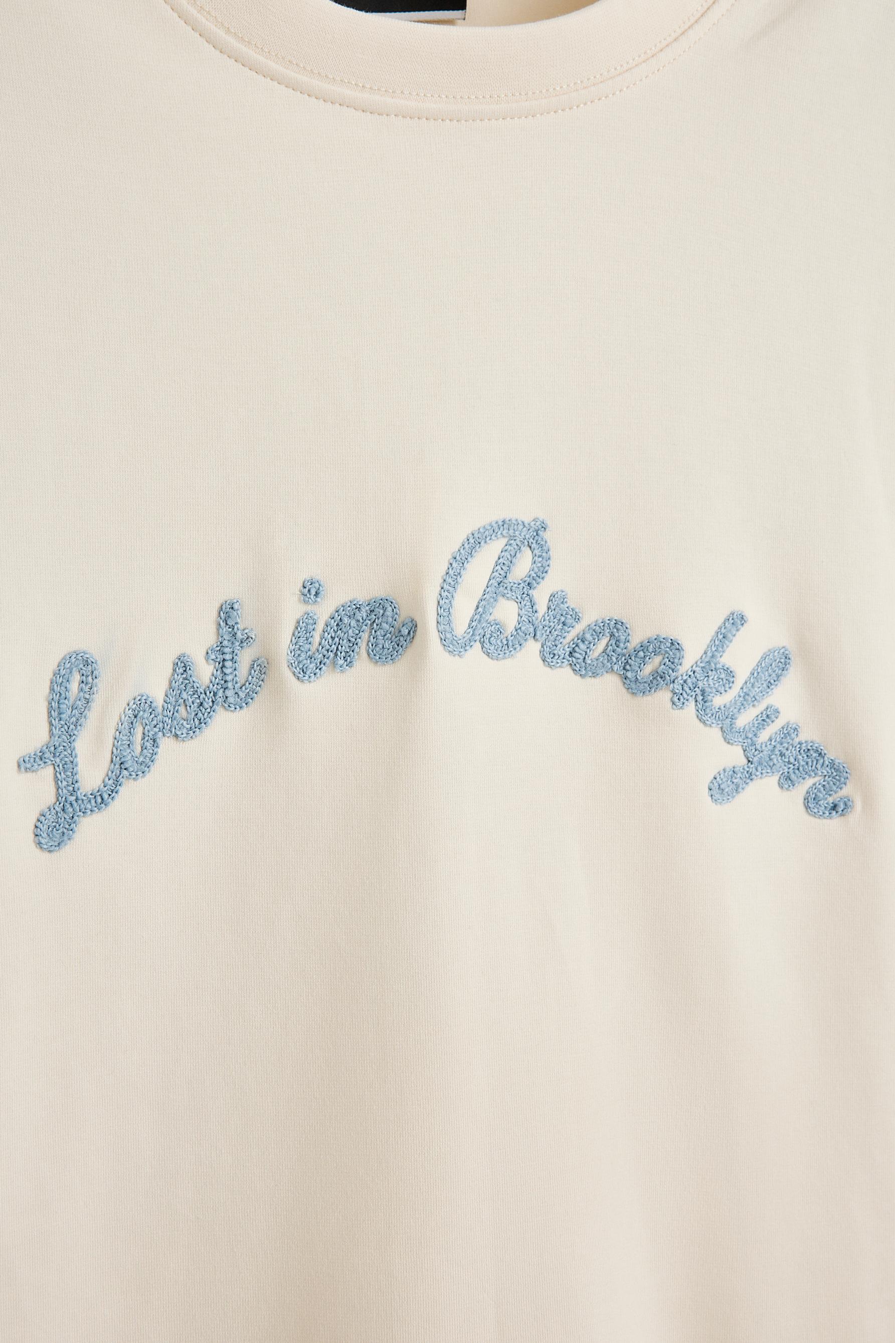 Embroidered interlock T-shirt — BUTTER