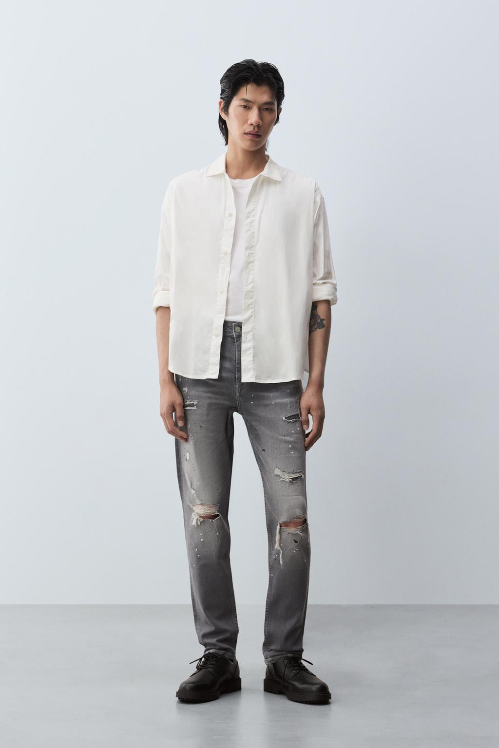 Jeans skinny cu rupturi și efect pătat