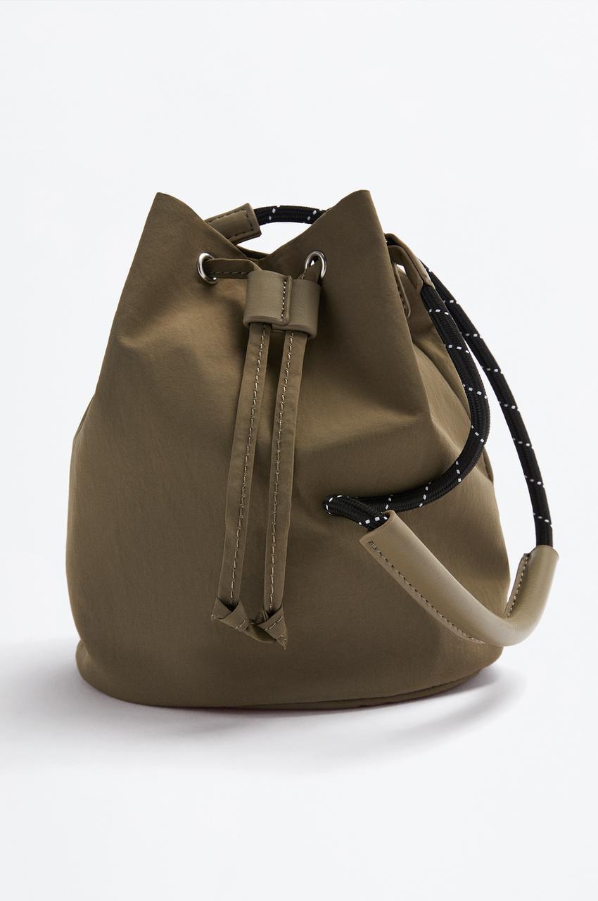 Bolso bucket trench con charm Mochilas Estuches ACCESORIOS