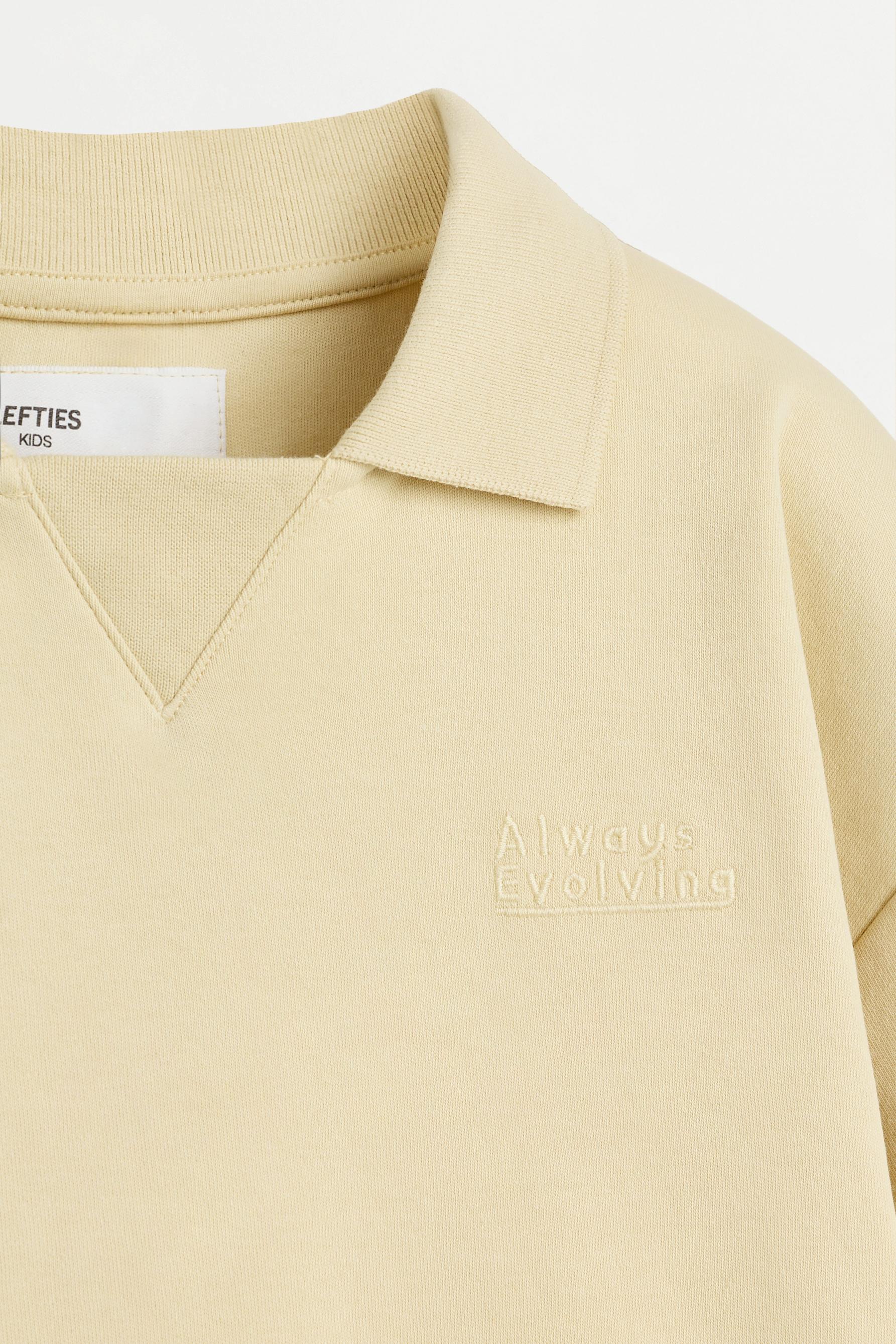 Interlock polo shirt with text — VANILLA