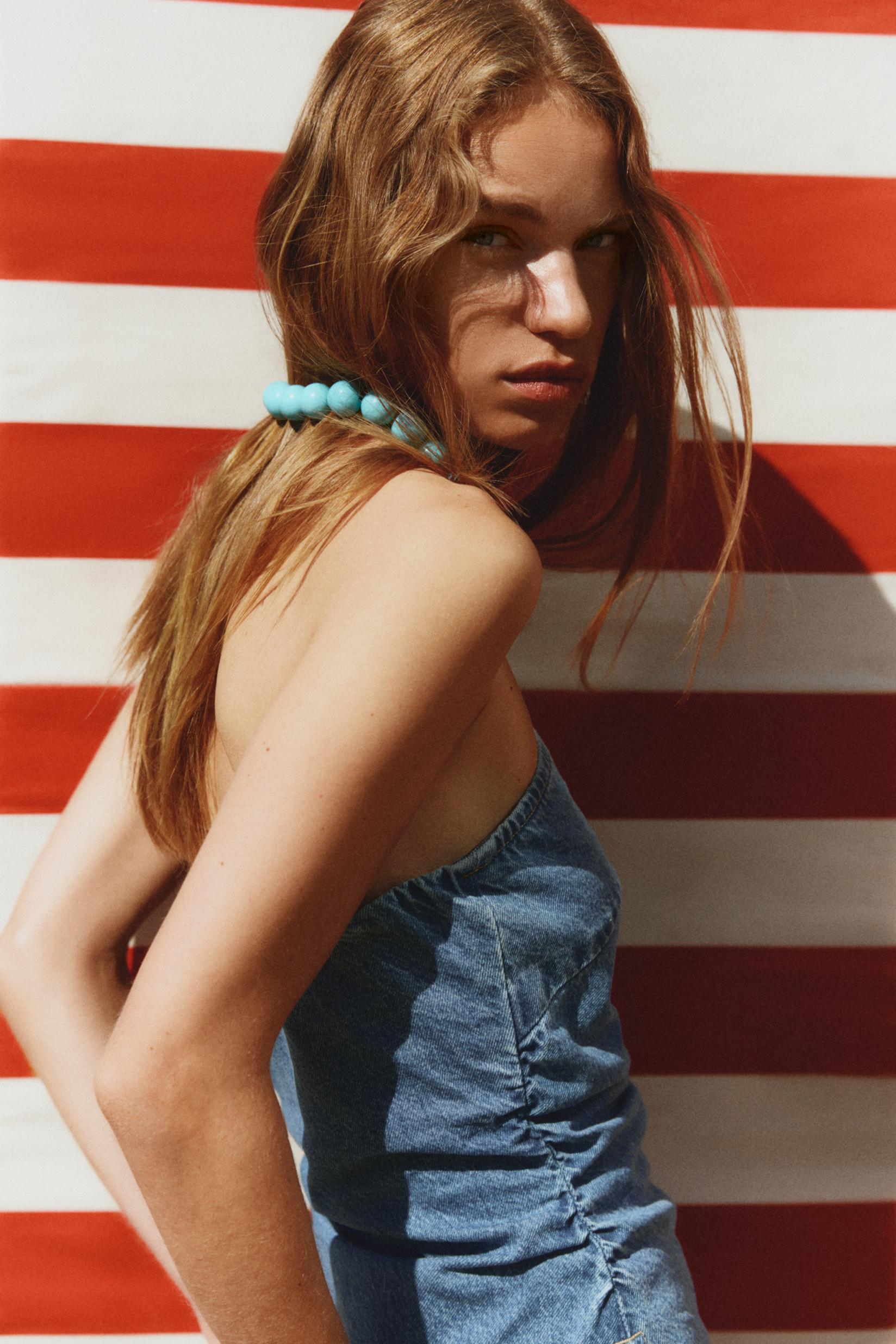 Asymmetric denim bandeau top with studs — PALE INDIGO