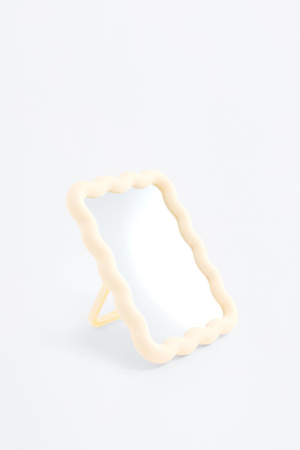 Mirror with irregular-shaped frame