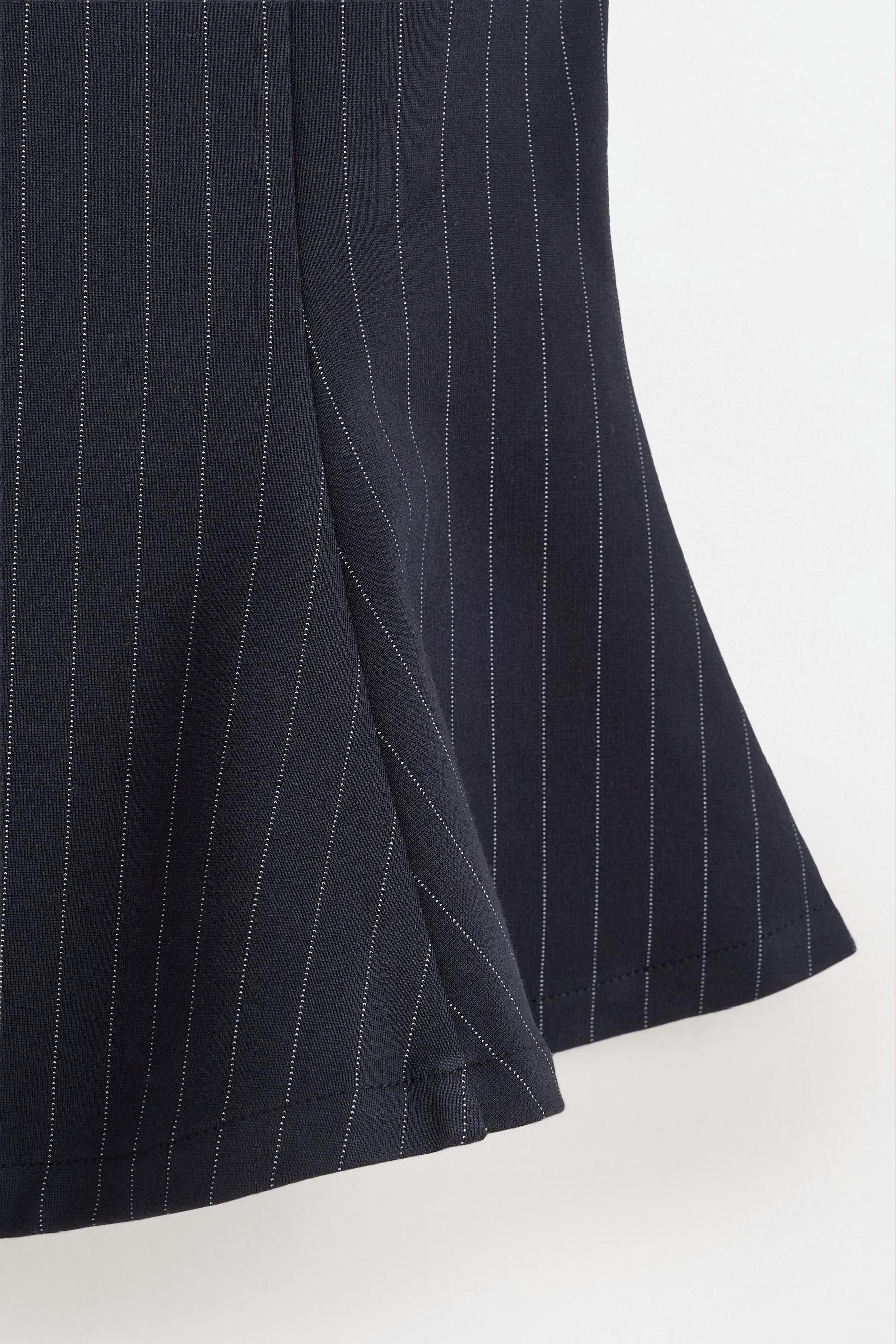 Interlock peplum top — STRIPED