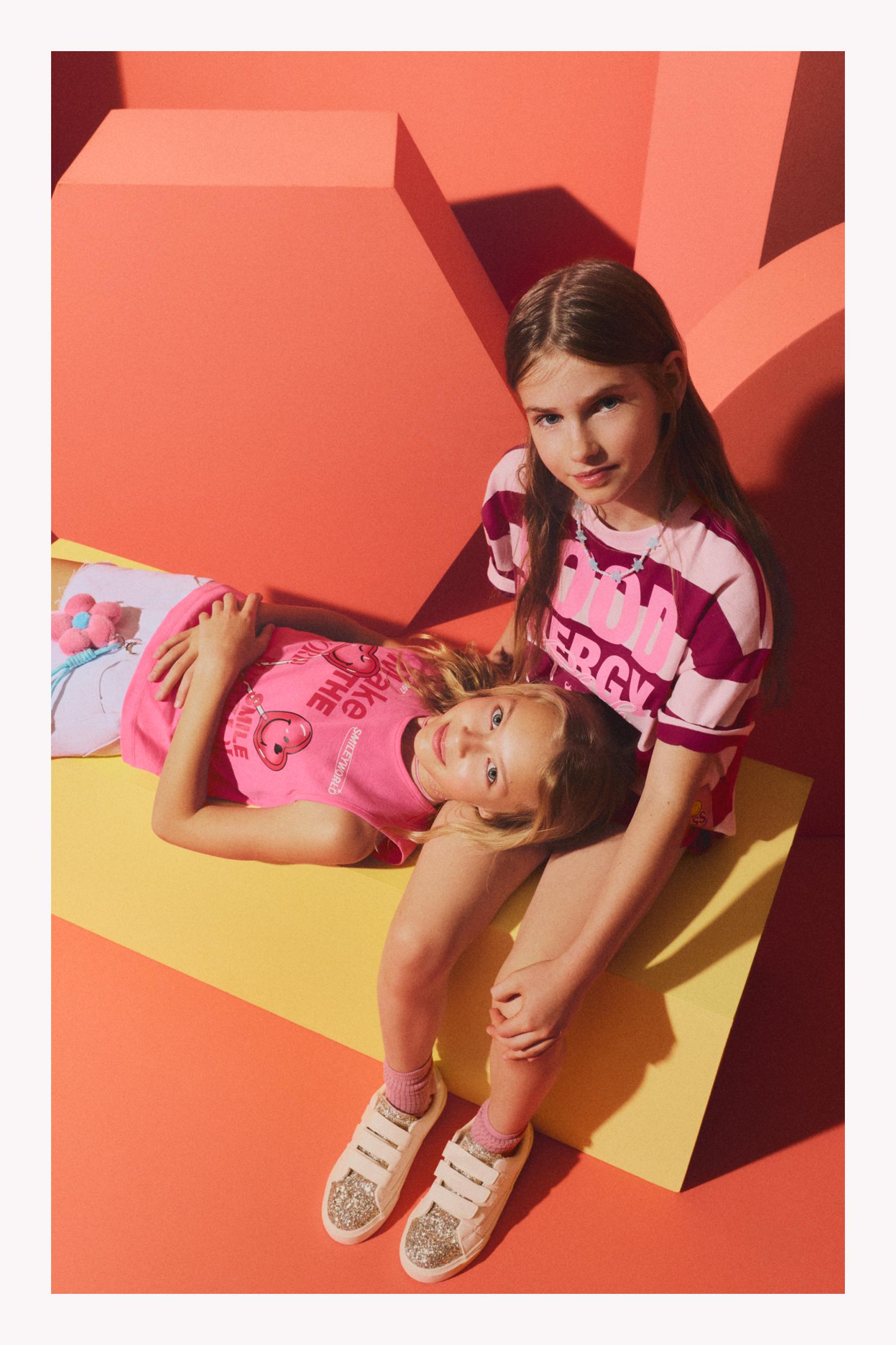 SmileyWorld® Sleeveless T-shirt — PINK
