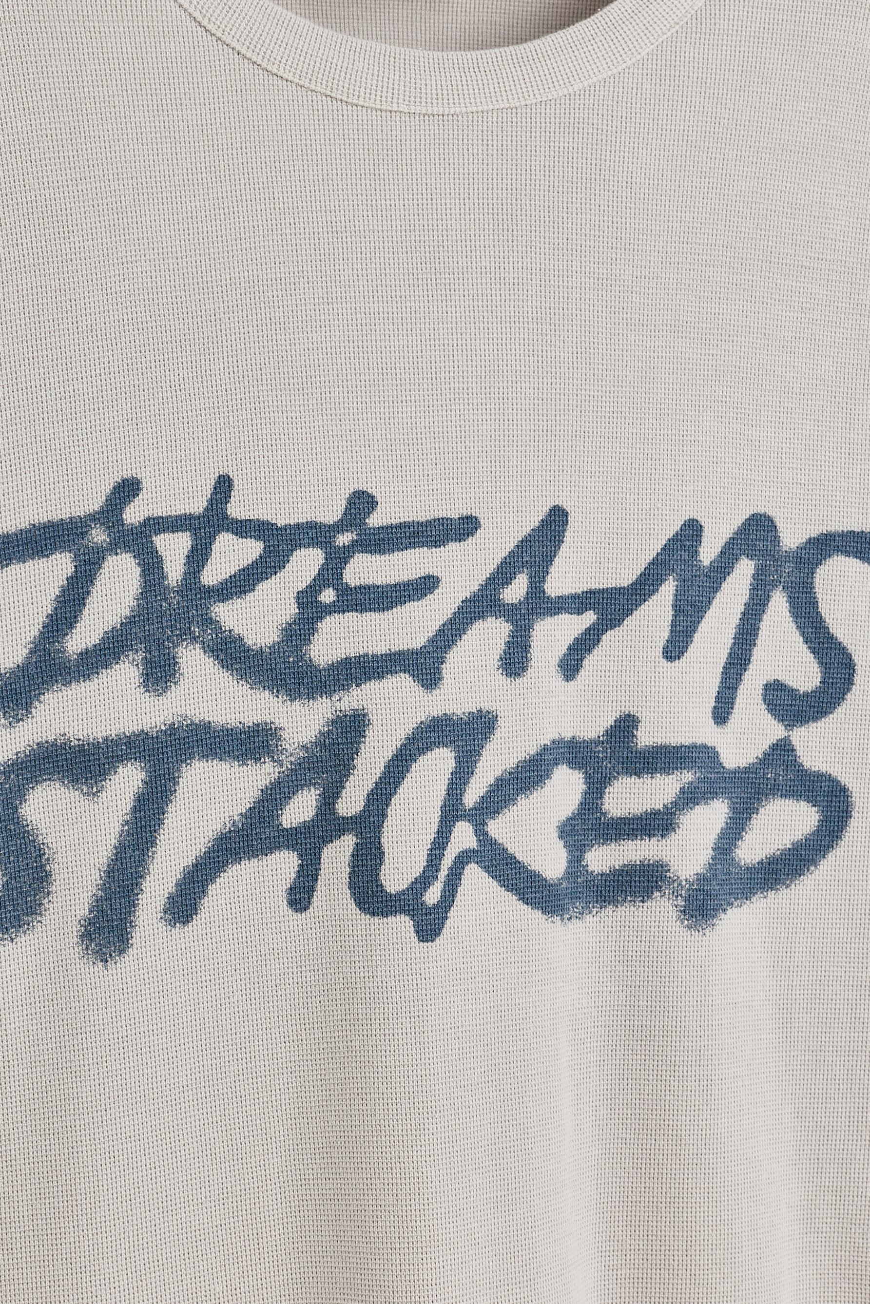 Faded-effect slogan T-shirt — STEEL