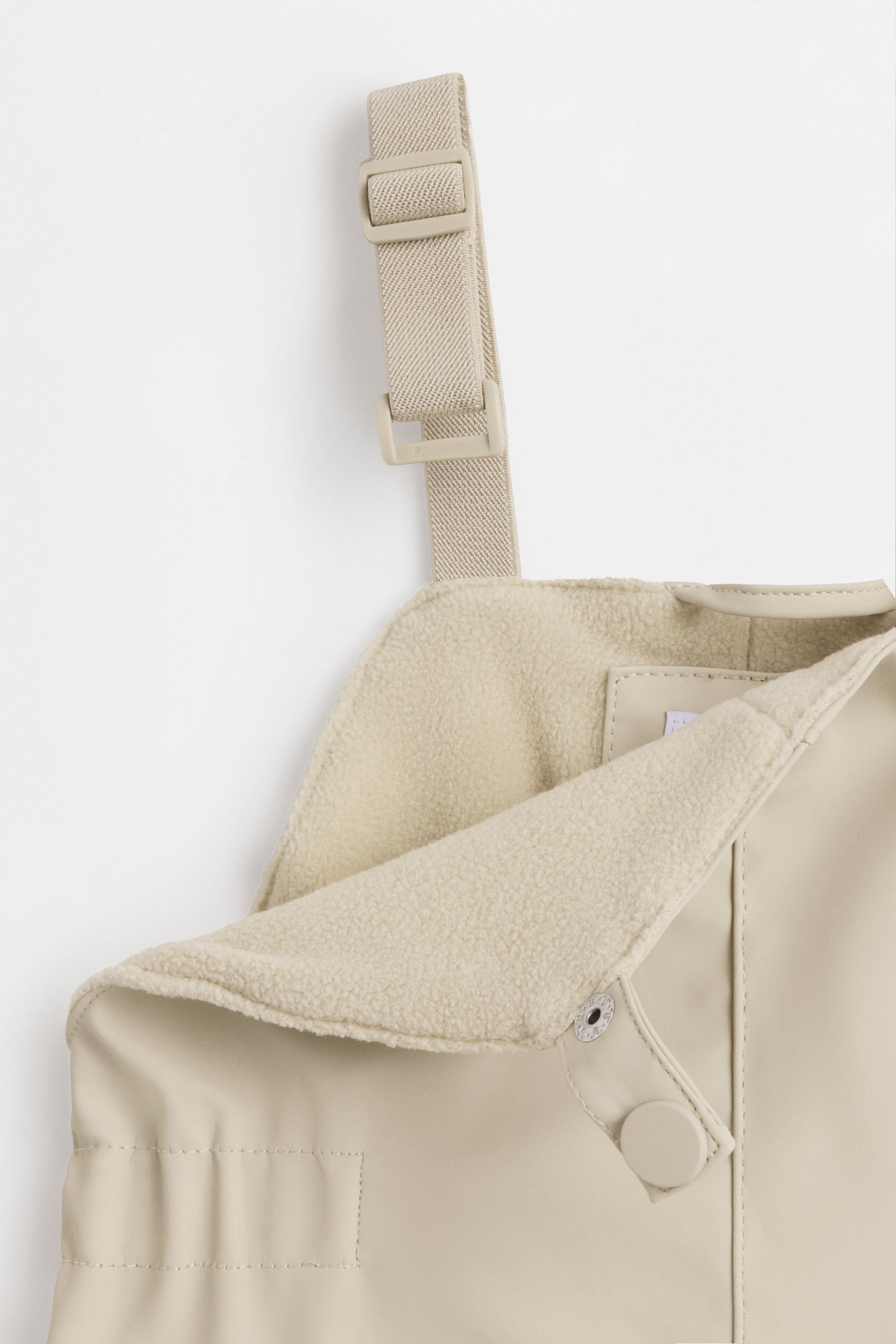 Rubberised fleece-lined dungarees — BEIGE