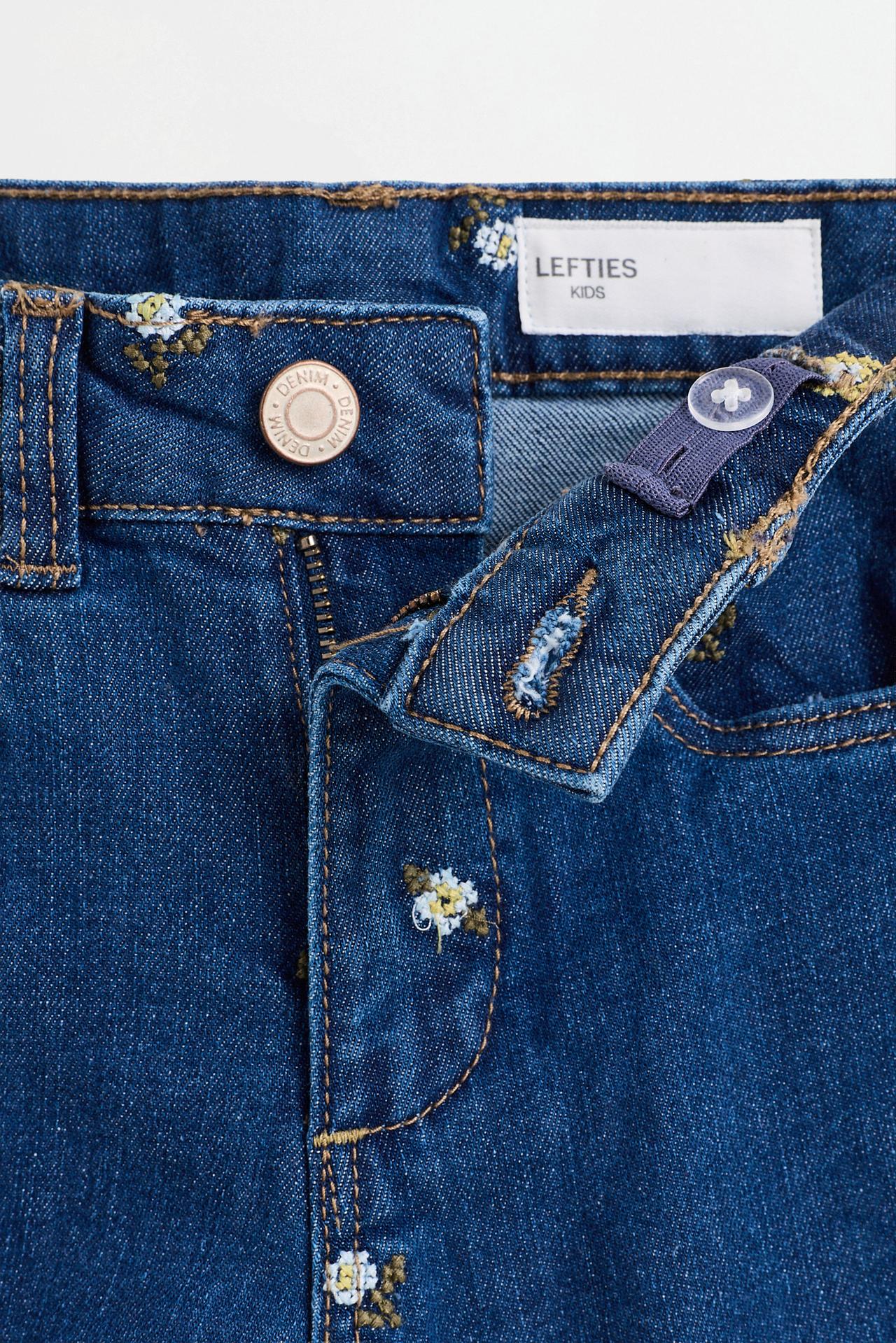 Floral embroidered bell bottom jeans — INDIGO