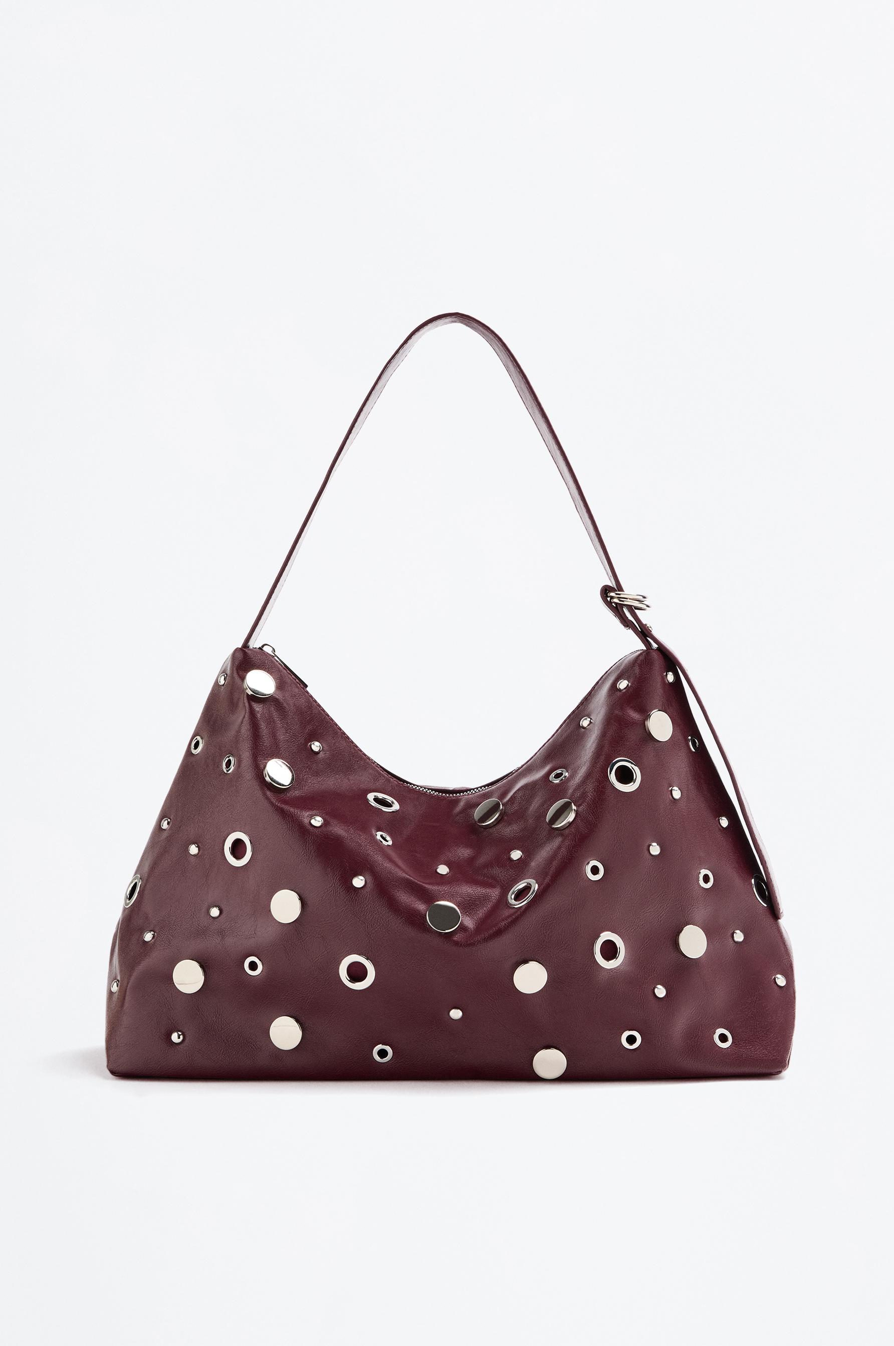 Bolso shopper tachas y eyelets