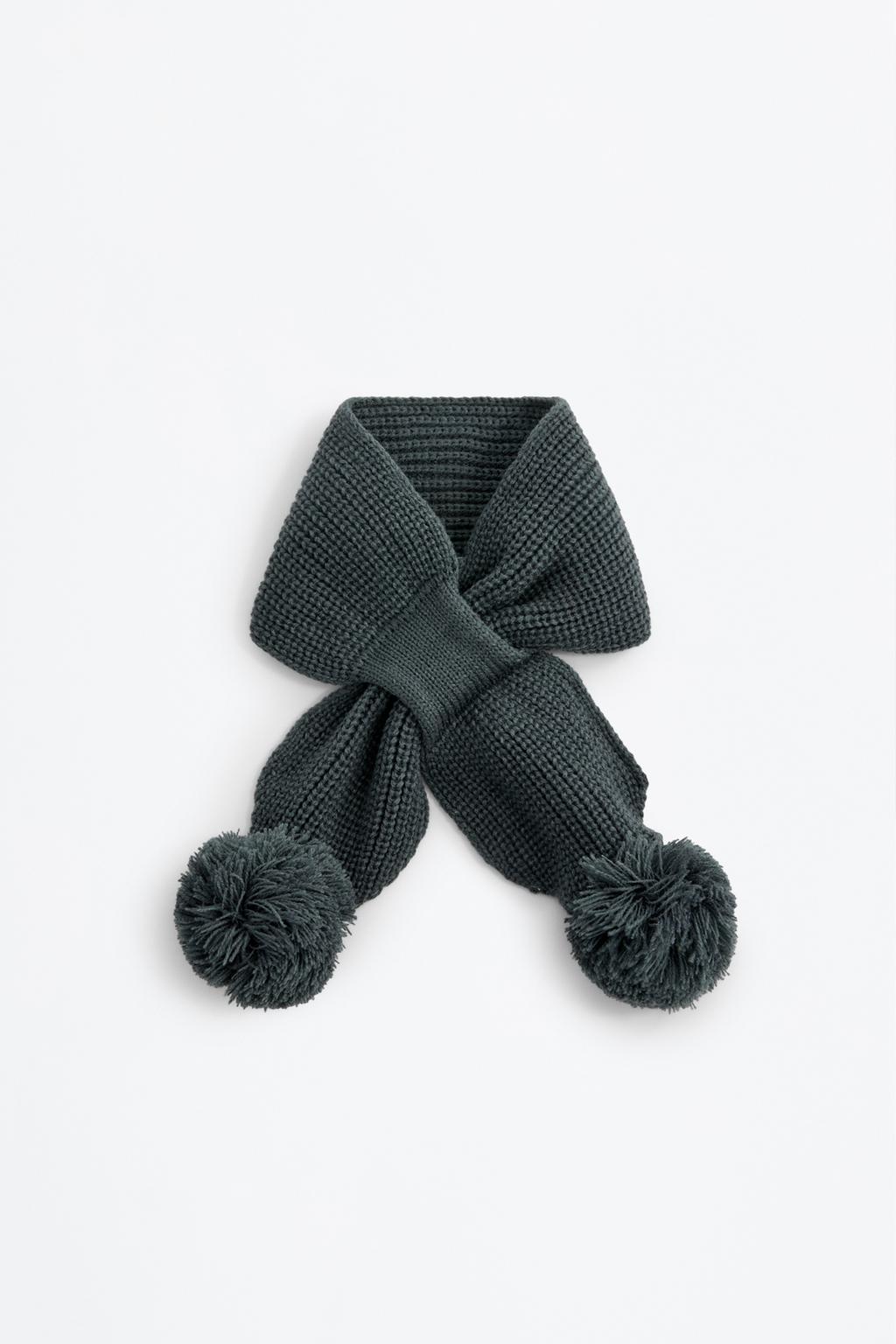 Criss-cross scarf with pompoms
