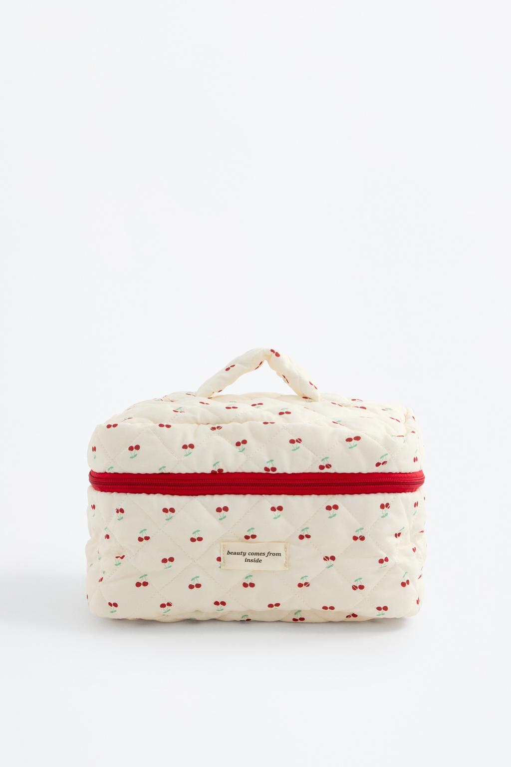 Quilted toiletry bag with handle and cherries